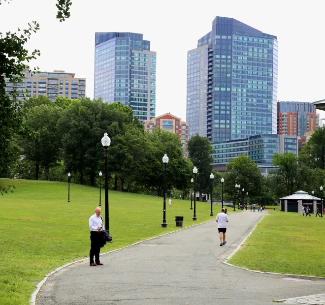 two men are jogging in a public park