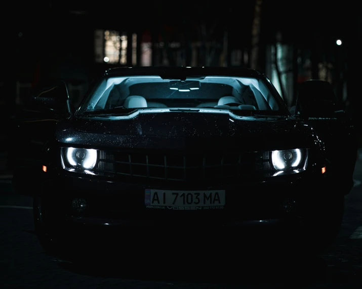 a car parked on the side of a road at night