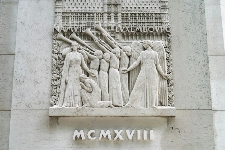 a stone relief depicting men and women near a wall