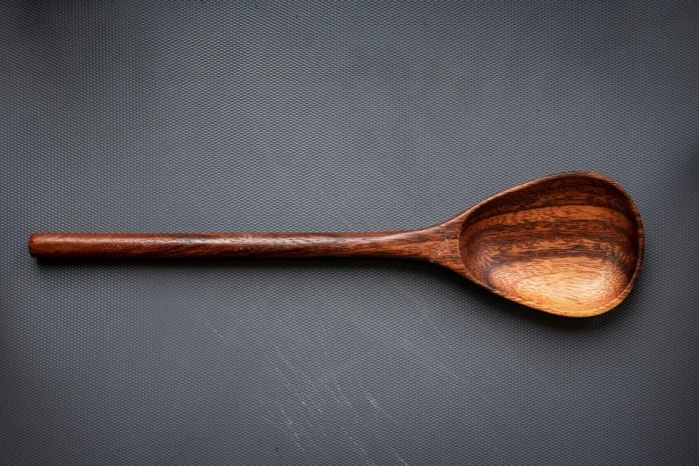a close up image of a wooden spoon