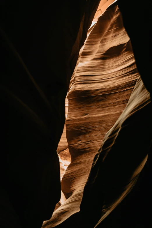 a rock in the desert has sunlight coming through