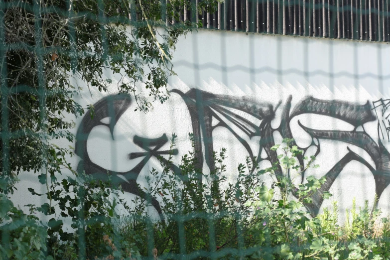 a graffiti - sprayed image on the side of a building