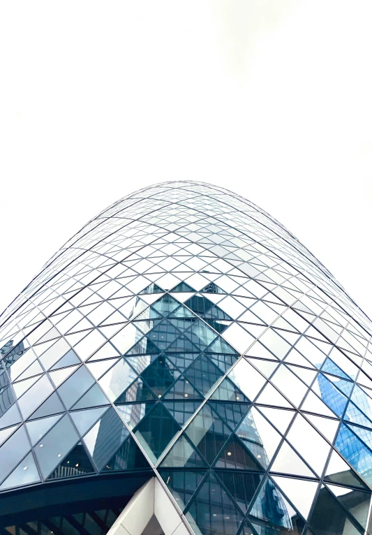 the glass facade of a building on an overcast day