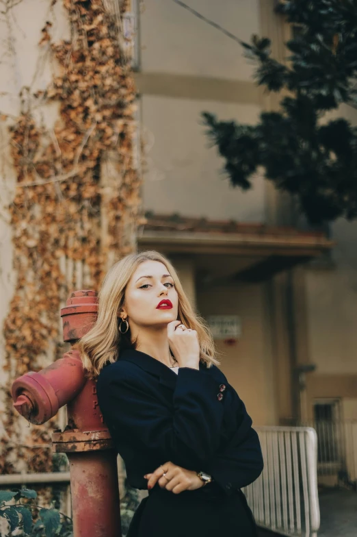 woman leaning on fire hydrant posing for camera