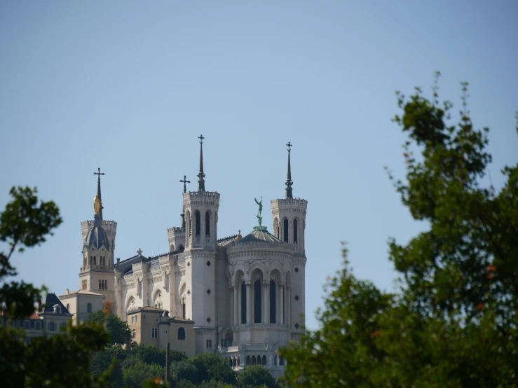 the spires and clock are visible at this beautiful castle