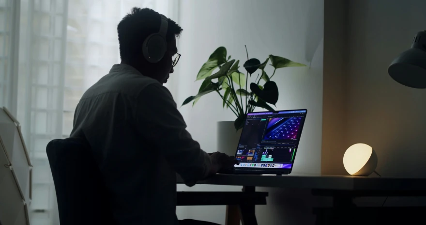 a man in headphones is sitting at a desk