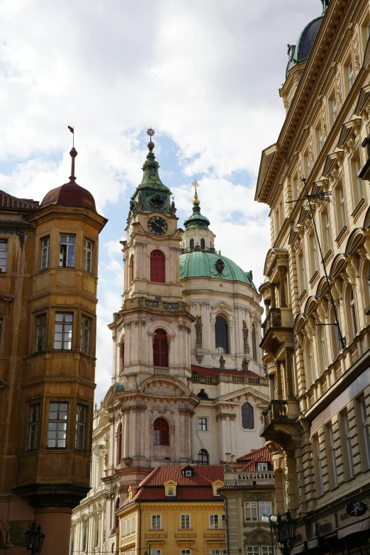 many buildings and one tower with a clock in the middle