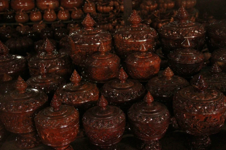 large pile of brown ceramic pottery pots next to each other