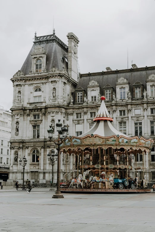 a carousel set up for a show at the edge of a courtyard