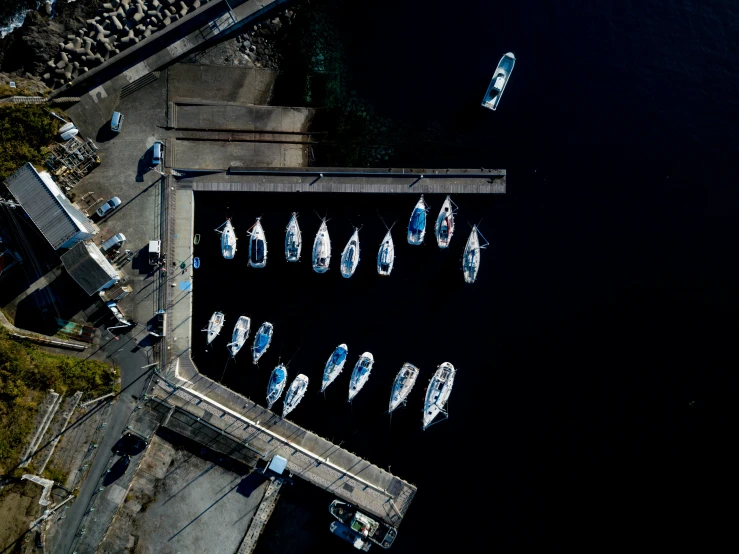 several white boats parked at a pier near water