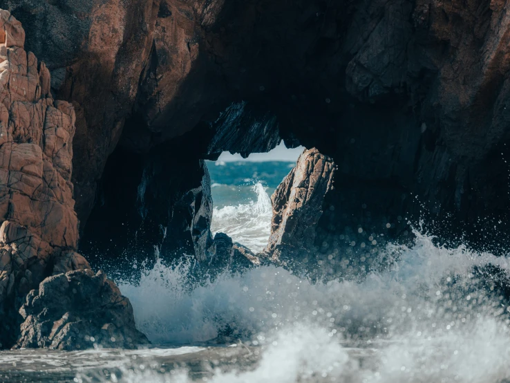 large waves crashing onto an ocean rock near the shore