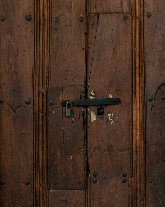 there is a large wooden door with metal hardware