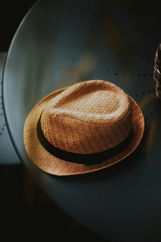 an older straw hat on a metal platter