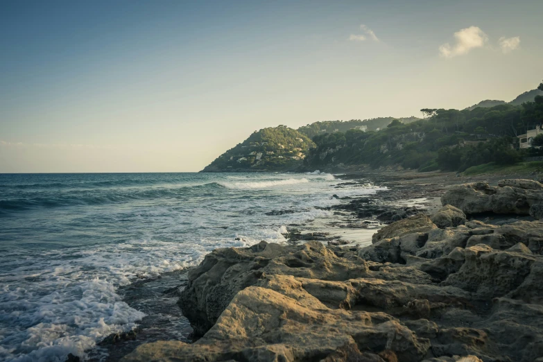 a rocky beach with some large waves crashing