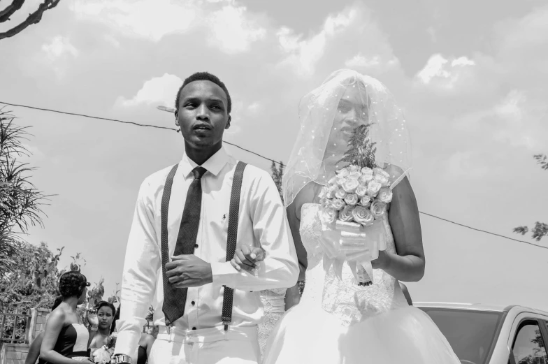 a man and woman are walking in their wedding attire