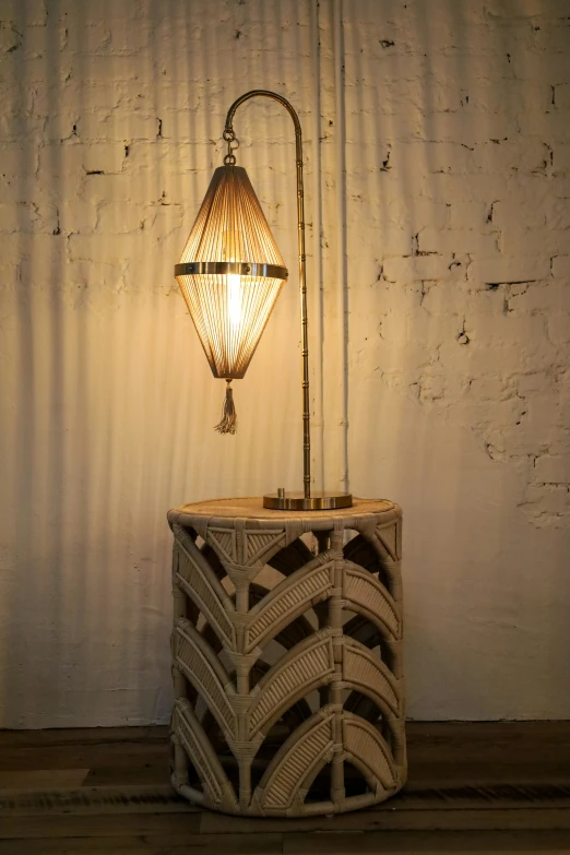 a small lamp with a basket underneath it