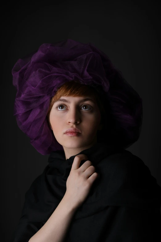 a young lady is posing in a purple turban
