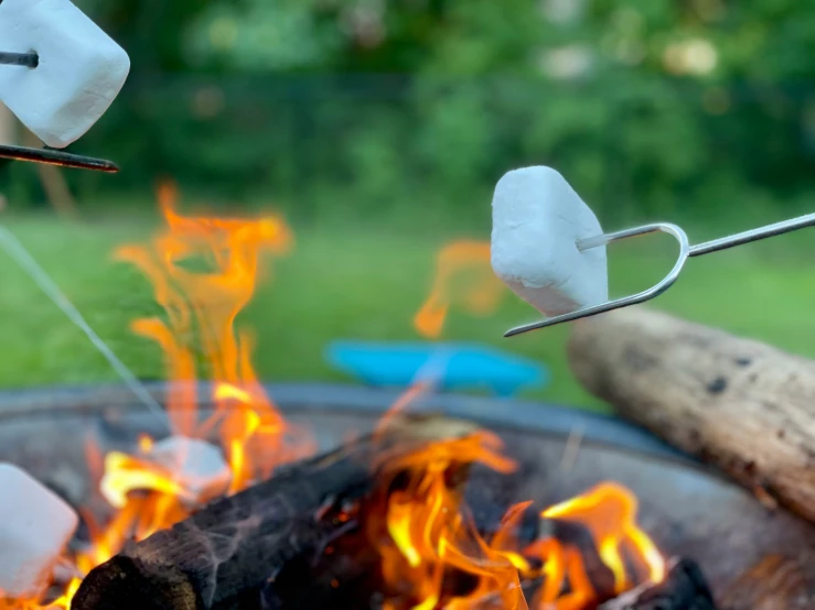 marshmallows being roasted over an open flame