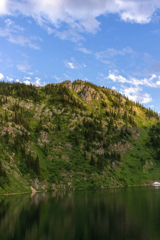 a boat on the water near a mountain