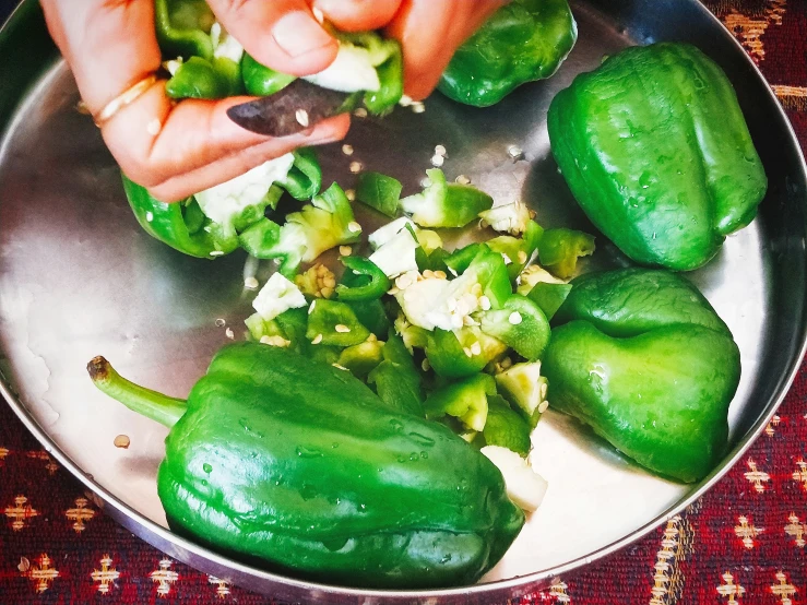 a pan filled with green peppers and white stuff