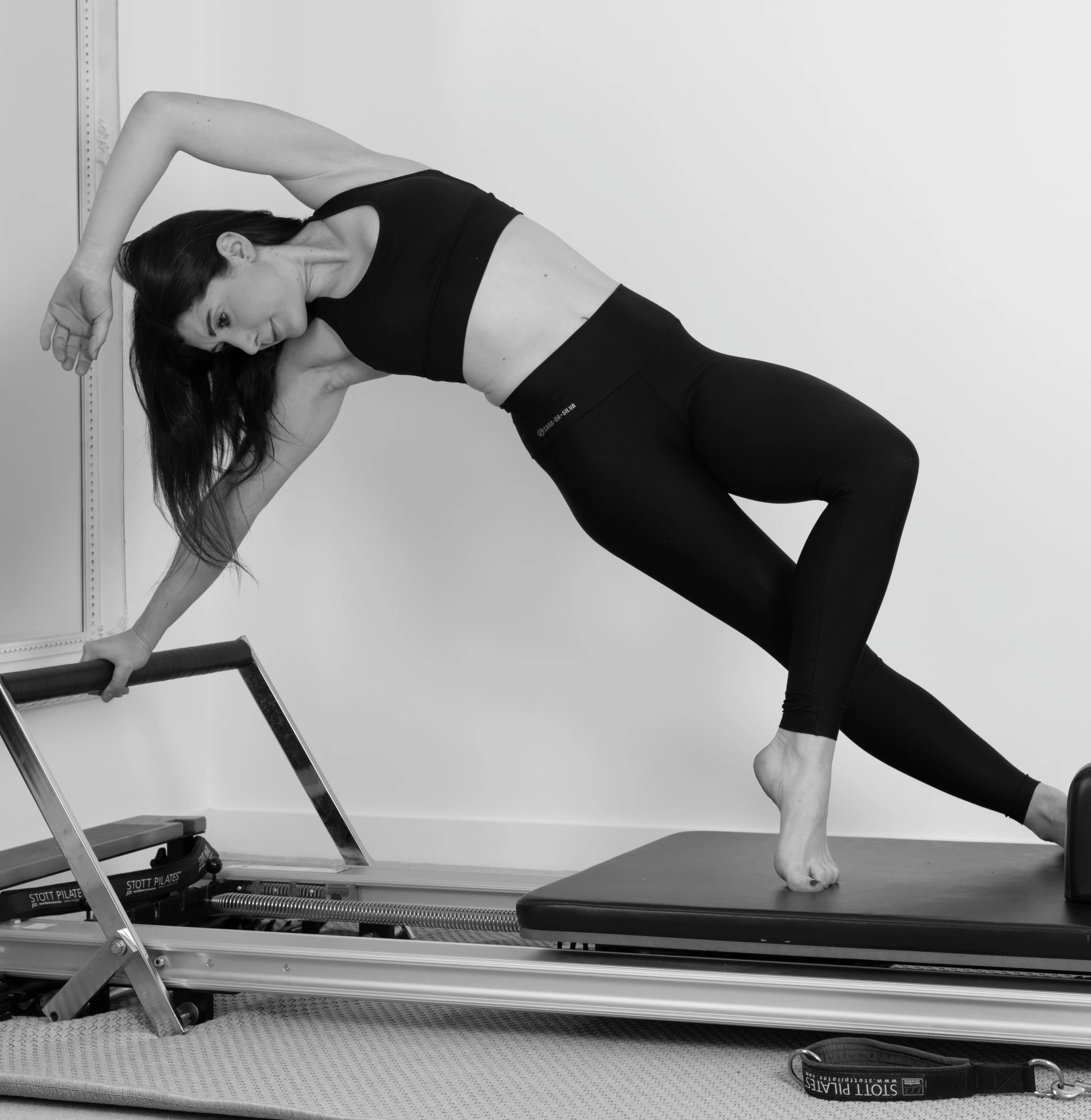 the woman is doing some stretching exercises on her treadmill