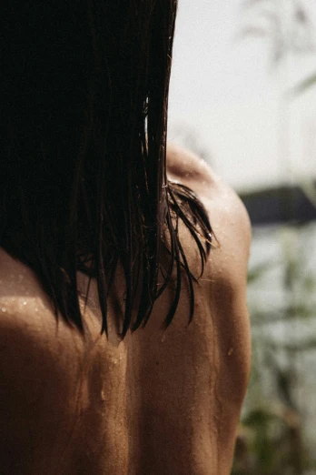 a man with long hair and bare back