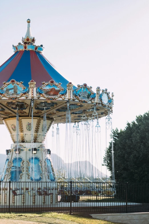 a small carousel is shown in front of the gate