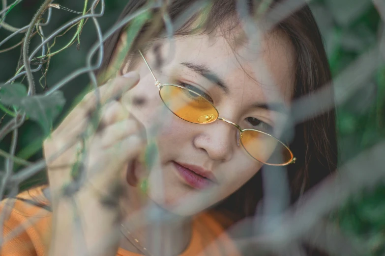 the woman wearing sunglasses behind a fence