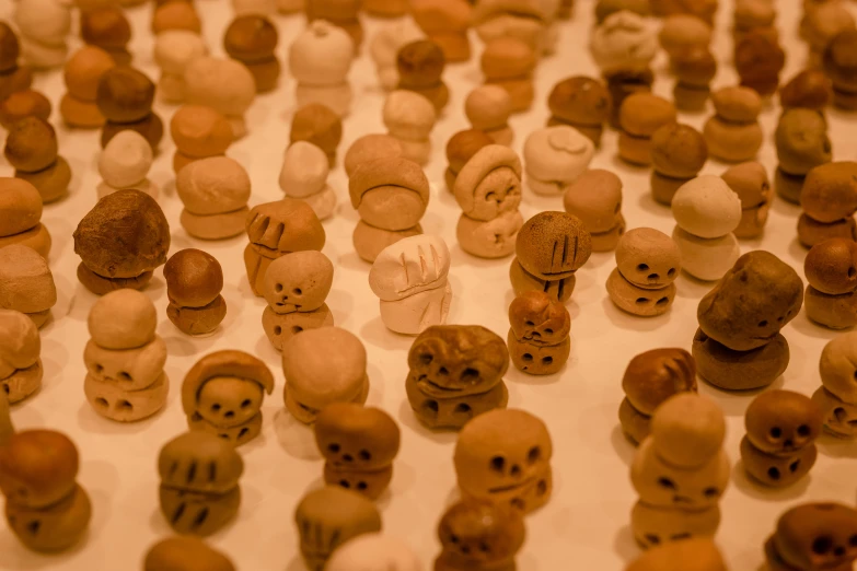a table full of small orange and brown skulls