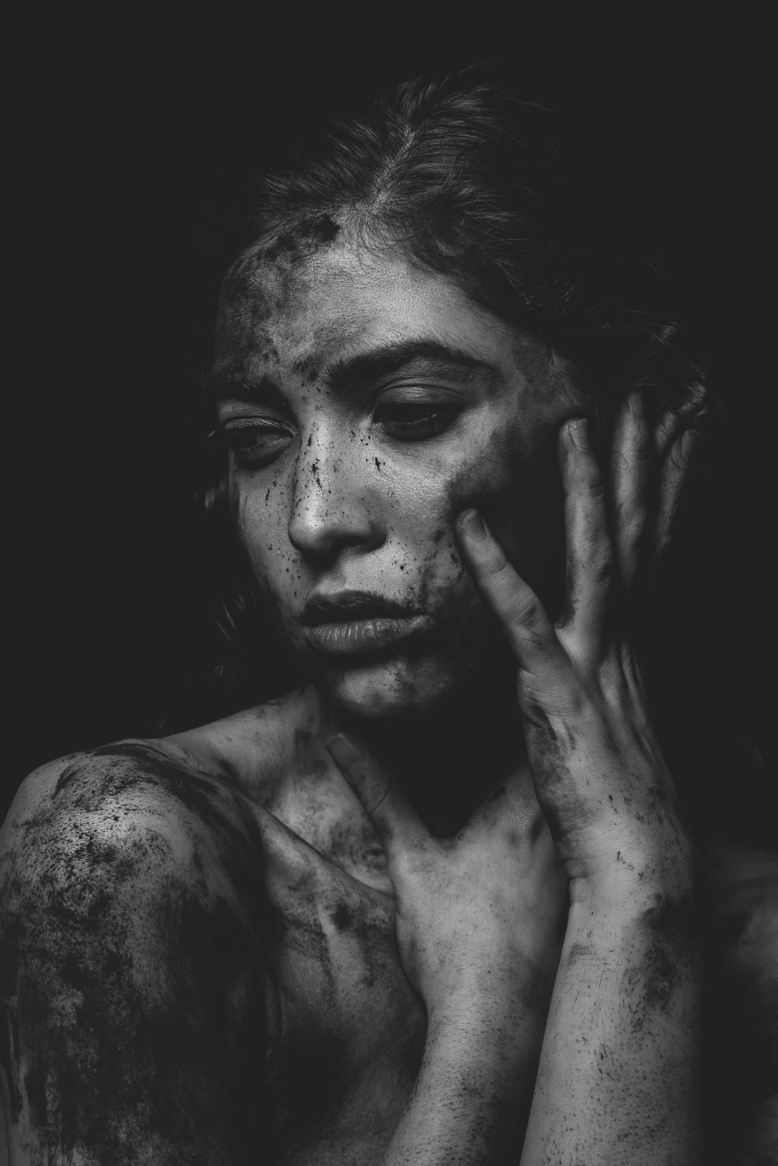 a young woman covered in mud posing for the camera