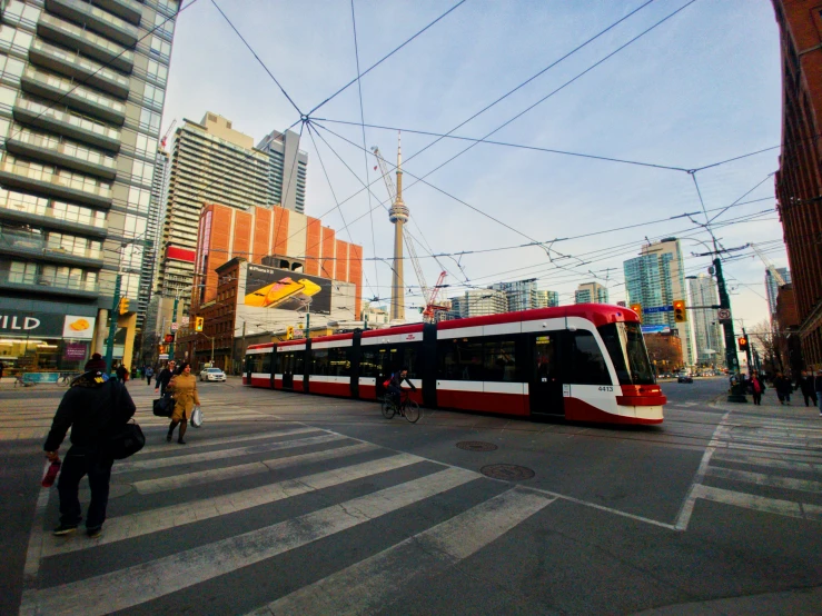 a long red and white train in the city