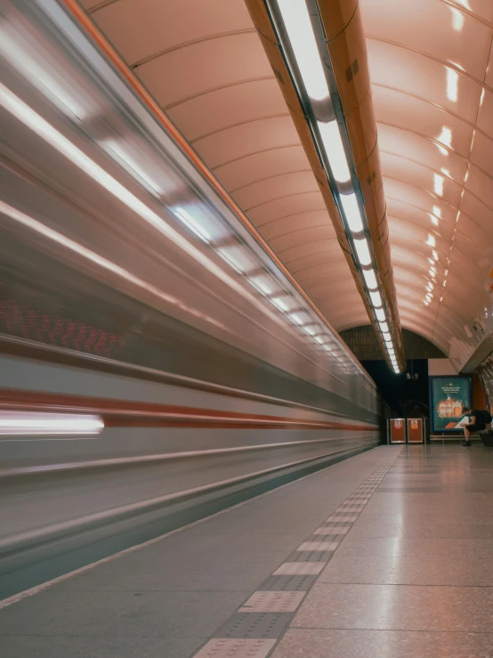 a blurry train traveling down the track at night