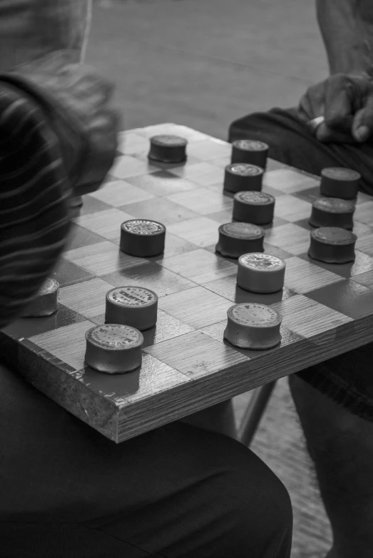 black and white pograph of a man playing chess