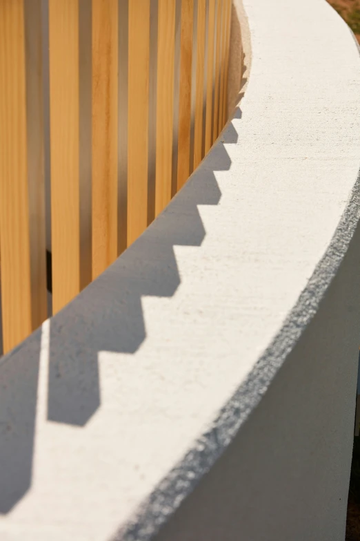 a bird sitting on top of a wooden fence