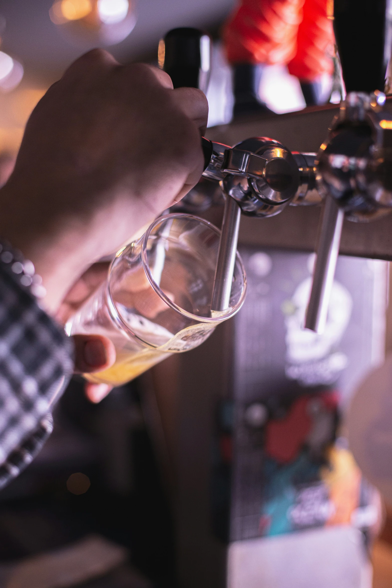 people are pouring drinks in a bar on a sunny day