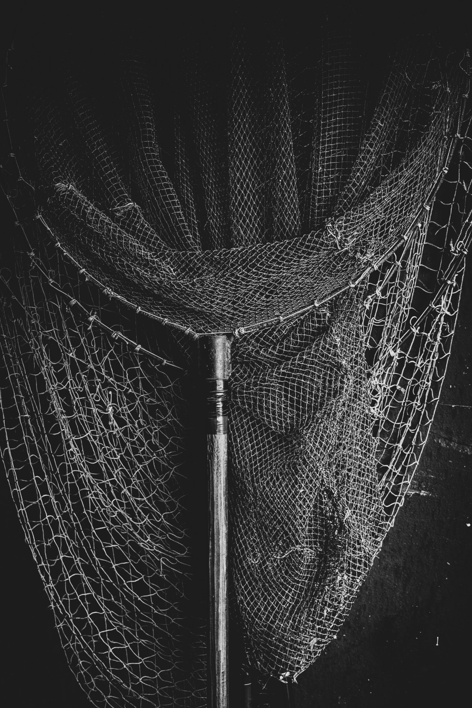 an artistic pograph of a metal pole and rope netting