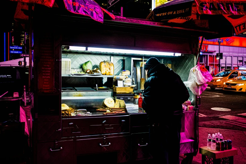 an image of a person cooking food outside at night