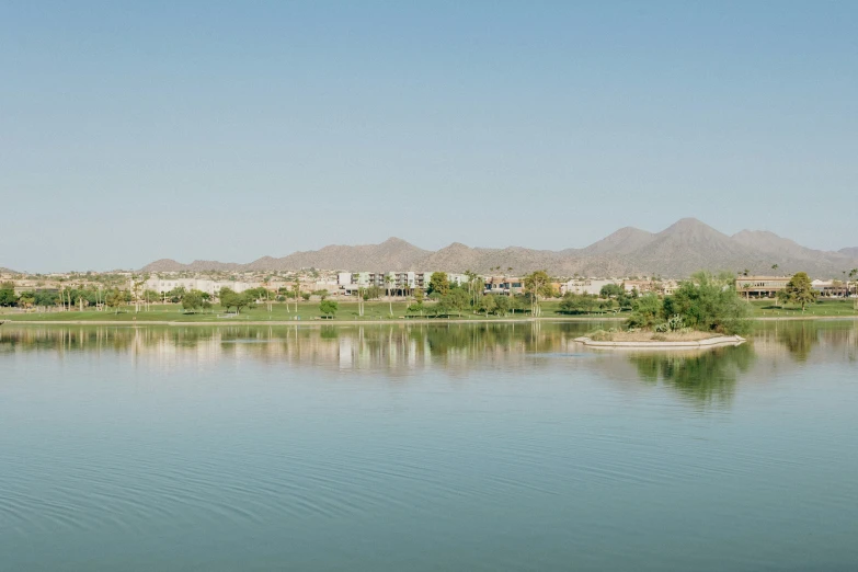 a large body of water surrounded by hills and trees