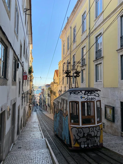 a trolley is going down a cobble stone street