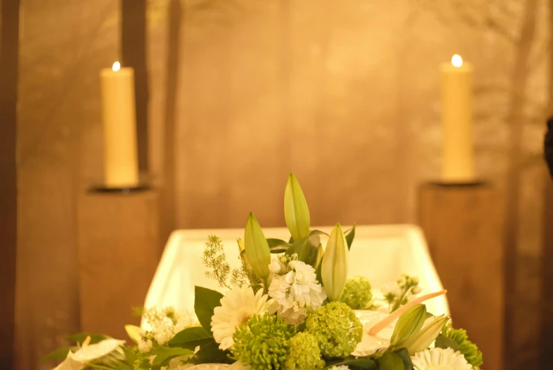 a table filled with different types of flowers and candles