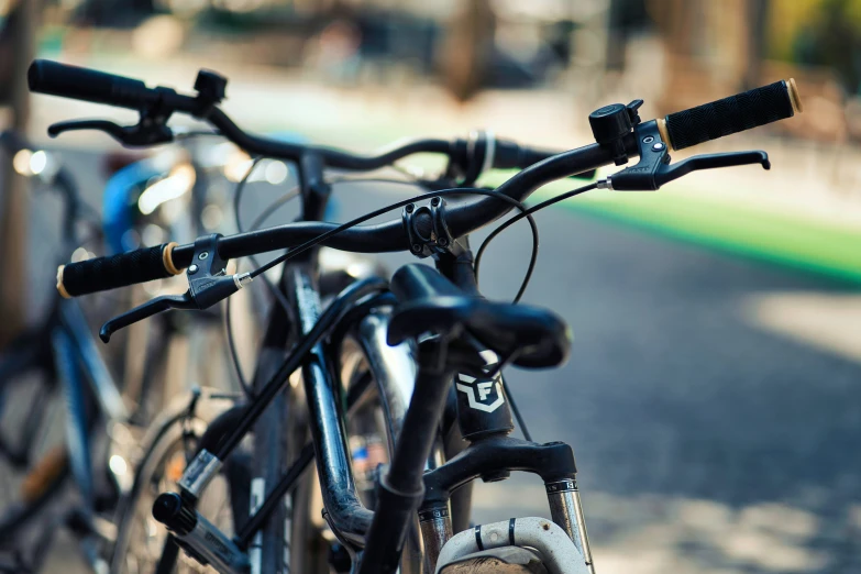 bicycles sitting in a line on a sidewalk