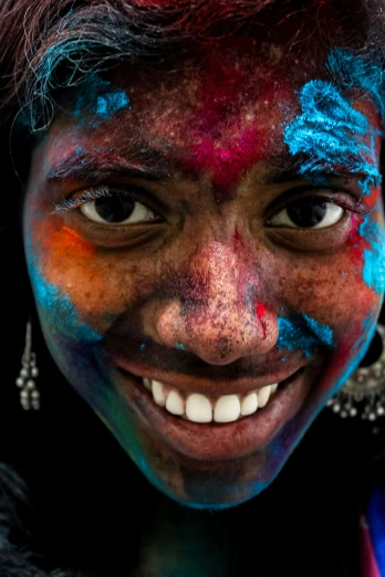 a woman with bright colors on her face and eyes
