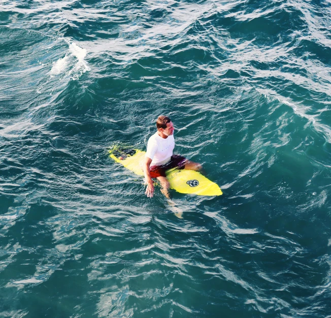 a man on his surfboard is riding through the water