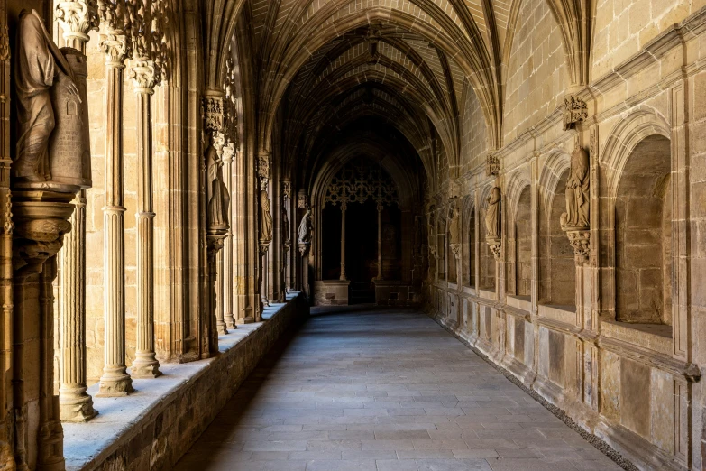 a hallway leading up to another room with large pillars