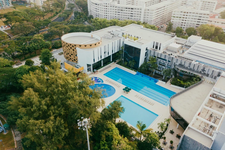 an aerial view of a city with an aqua pool