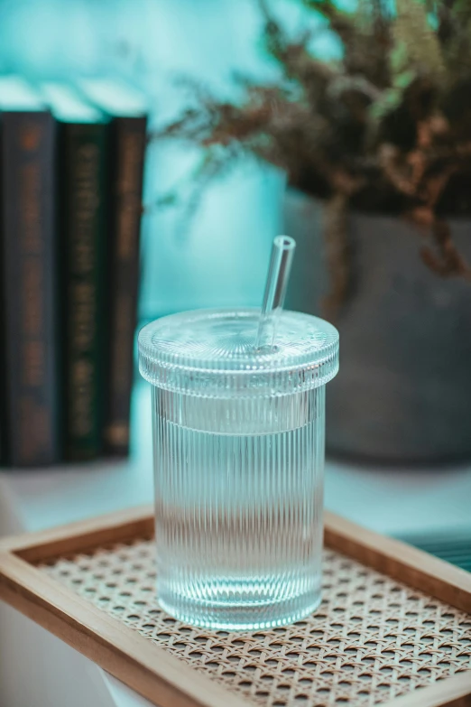 a clear glass on top of a wooden tray