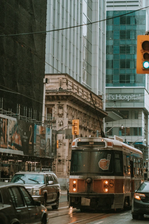 a public transit bus driving down a wet city street