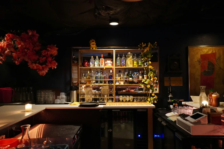 a well lit bar with alcohol bottles and candles on top