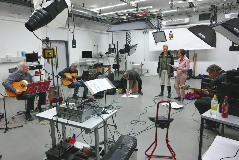 a group of people in a studio playing instruments