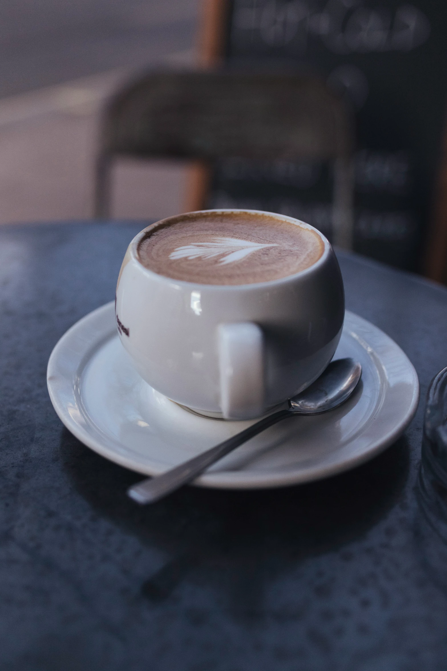 a cappuccino with a spoon sits on the table